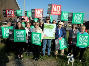 Members of Coalition Against the Proposed Prison (CAPP) stand with other local residents at the former Kemptville College campus — a site that is being proposed for a new provincial jail.