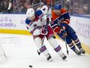 New York Rangers Jacob Trouba battles Edmonton Oilers Connor Brown for the puck, Nov. 23, 2024.