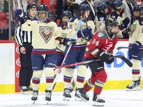 Montreal Victoire's Mikyla Grant-Mentis (left) celebrates her goal as Ottawa Charge's Anna Meixner skates away during the second period on Friday night.