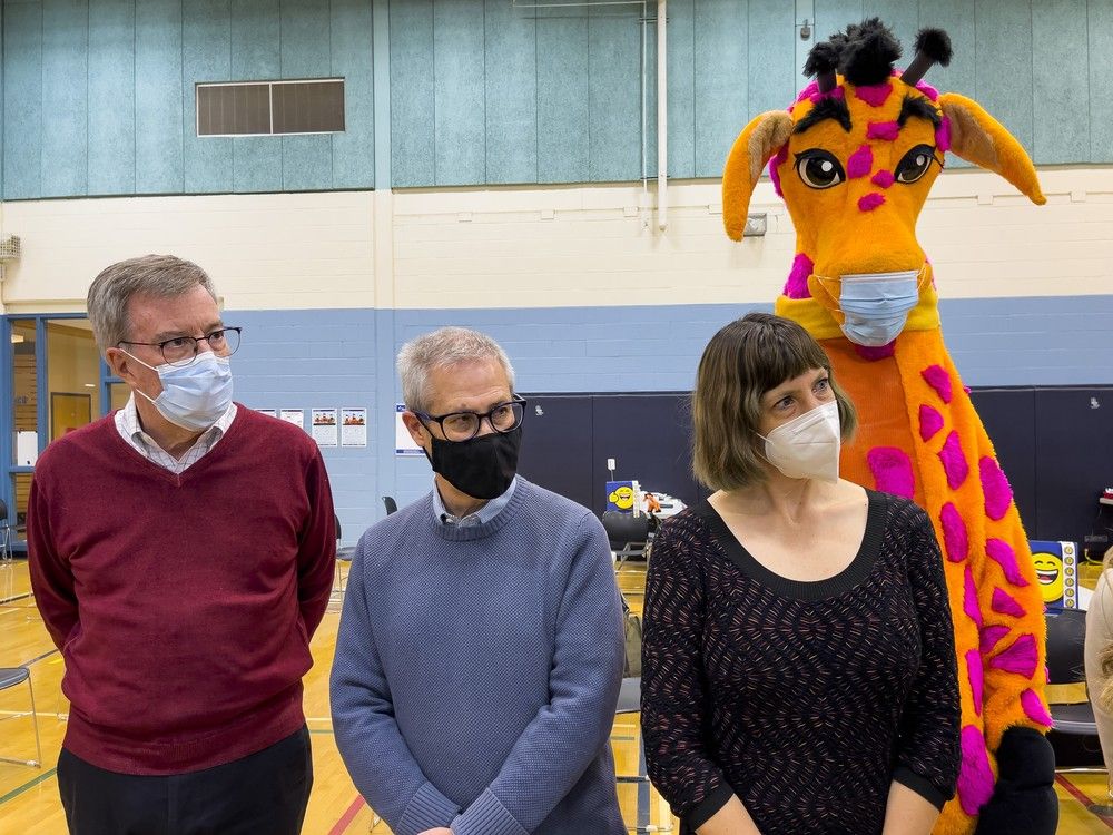  preparations were underway by ottawa public health at the eva james memorial centre in november 2021, they administered covid-19 vaccines to children aged 5-11. mayor jim watson, keith egli, chair of the ottawa board of health, and gerri the giraffe, listen as dr. vera etches addresses the media.