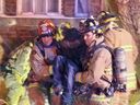 Firefighters assist a resident who suffered smoke inhalation at a fire Wednesday on Bronson Avenue. The person was not seriously injured, firefighters said.