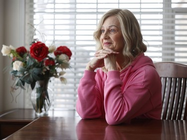 Julie Booker poses for a photo in her Ottawa home Monday. Julie is a breast cancer survivor who struggled with many of the costs associated with her cancer diagnosis.