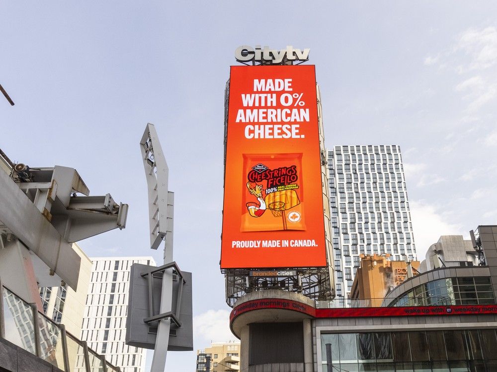  an ad for canadian-made black diamond string cheese dominates a billboard at the corner of victoria and dundas streets in toronto on feb. 11, 2025.