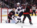 The Columbus Blue Jackets' Boone Jenner looks for a chance on Ottawa Senators goaltender Linus Ullmark as a shot goes wide of the net during the first period at the Canadian Tire Center on Sunday, April 6, 2025.