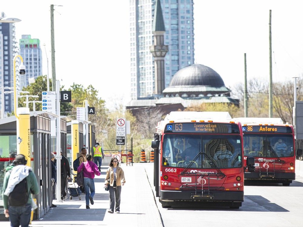  Passengers at Tunney’s Pasture board the buses on a sunny Ottawa day.