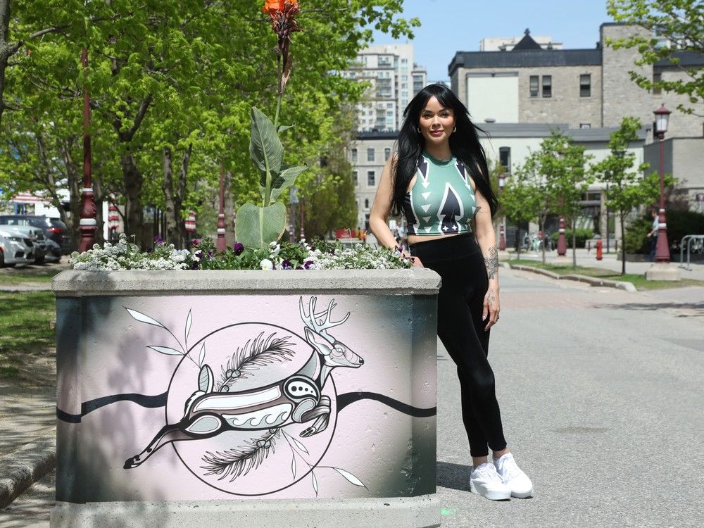  Tareyn Johnson is the director of Indigenous affairs for the University of Ottawa. She is seen next to a planter that was wrapped with designs by artist Terry Dactel. The University of Ottawa announced last week that they will waive tuition fees for Algonquin undergraduate and graduate students.