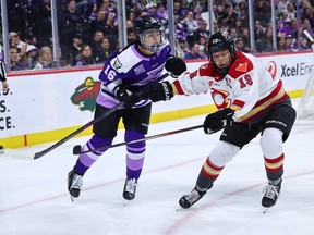 Sophie Jaques of the Minnesota Frost and Brianne Jenner of the Ottawa Charge battle for the puck during the first period at Xcel Energy Center on May 26, 2025 in St Paul.