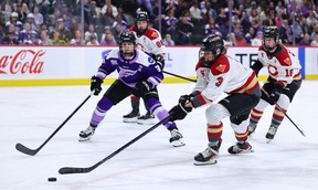 Zoe Boyd of the Ottawa Charge reaches for the puck while Brooke McQuigge of the Minnesota Frost pursues the play during the second period at Xcel Energy Center on May 26, 2025 in St Paul.