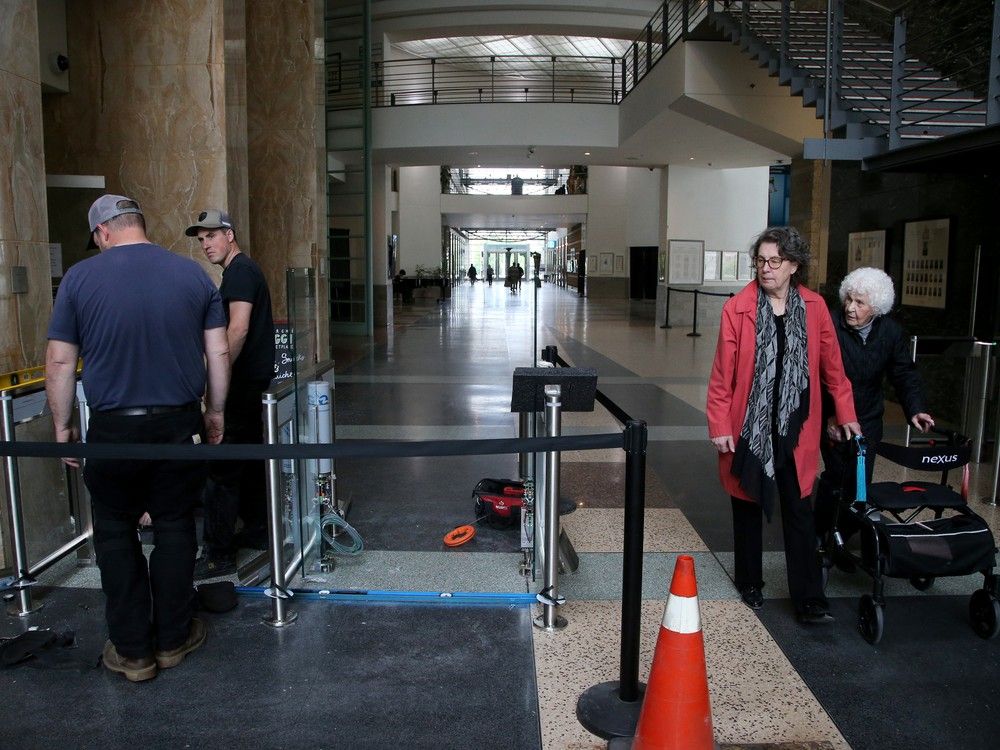  Seen through the City of Ottawa logo, new security equipment was being installed at the main entrance of Ottawa City Hall on May 21. The city will soon x-ray bags and put people through metal detectors before they’re allowed into city hall.