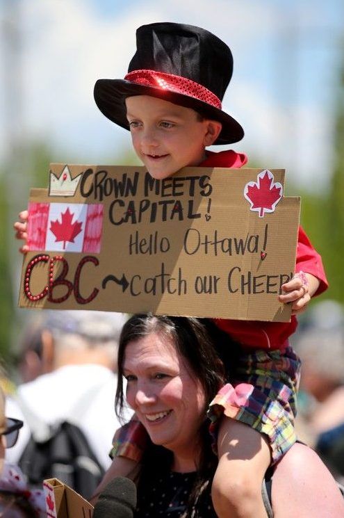  A pair of fans get decked out for the royal arrival.