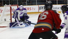 Emily Clark of the Ottawa Charge scores on Minnesota goalie Nicole Hensley in overtime