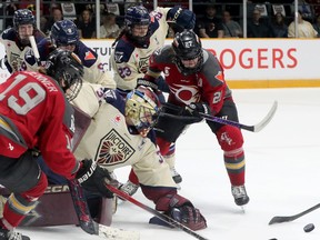 Montreal Victoire goalie Ann-Renee Desbiens eyes the puck in a scramble in front of her net
