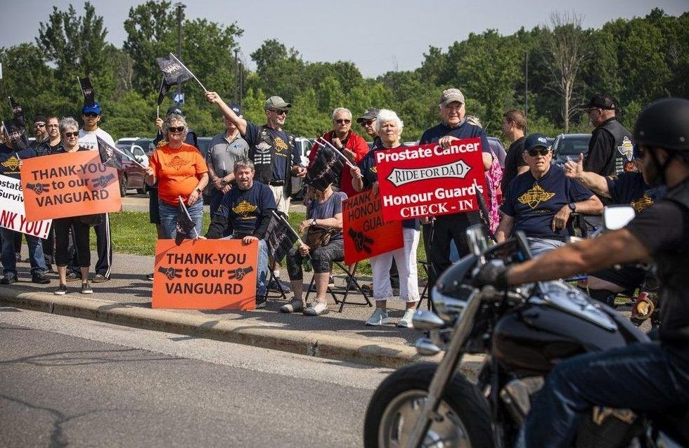  As the bikes pulled out, a group known as the Vanguard — prostate cancer survivors and their supporters in matching blue shirts — lined the route, cheering riders on.