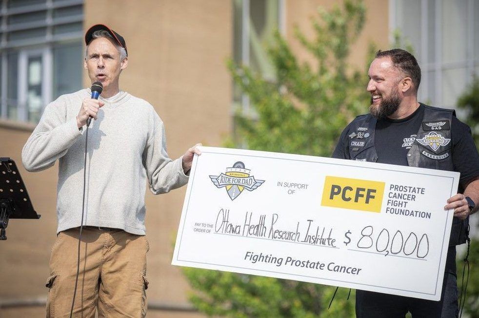  Graham Thompson, director of philanthropy with The Ottawa Hospital Foundation, accepts the extra large $80,000 cheque from the ride’s local chair, Michael Anderson.
