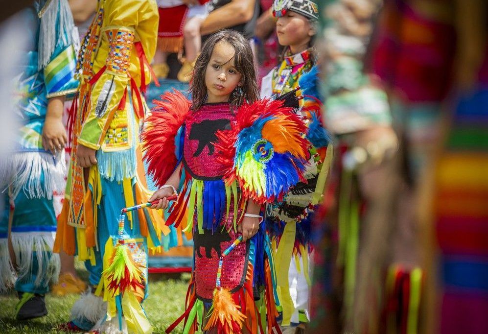  Dancers gathered for the Grand Entry to begin the powwow Saturday afternoon under the hot sun, their regalia dancing in the wind and shimmering with vibrant, stunning colours.