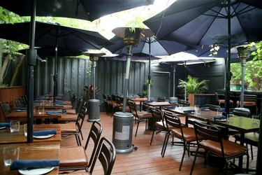 A patio shaded by umbrellas on a wooden deck