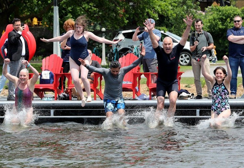  NCC CEO Tobi Nussbaum (second from right) was joined by local MP Yasir Naqvi (centre) and former MP Catherine McKenna (left) and others for a splashy opening of swimming season at the brand new Dow’s Lake Dock.