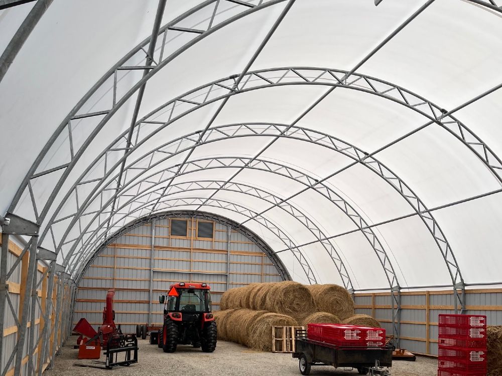 Ease of construction, economical cost, long life and great interior light are the advantages of fabric structures for storage workshop or livestock housing.