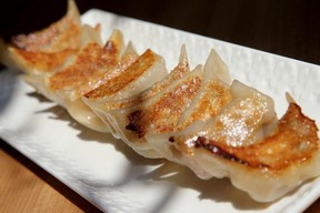 A white dish lined with dumplings