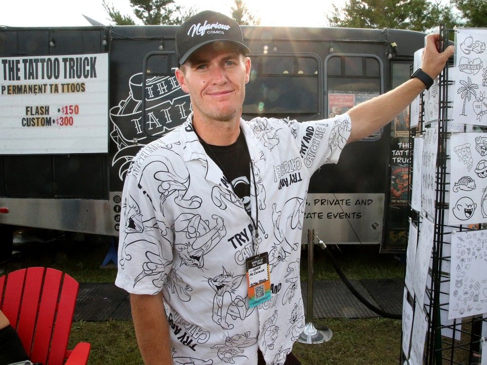  Luke McCormick in front of his portable tattoo truck on site at Bluesfest this year.