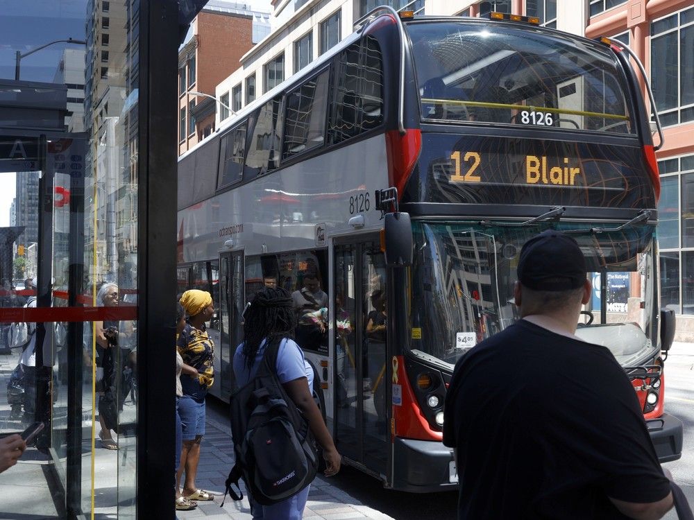  Rider board an OC Transpo bus in downtown Ottawa Wednesday.