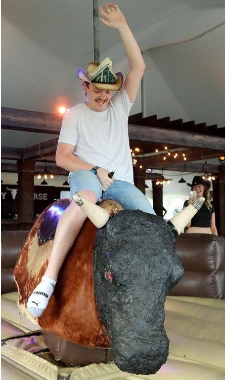  Quinn Meeker takes his shot at riding the mechanical bull Jed at the Crazy Horse saloon on site at Bluesfest.