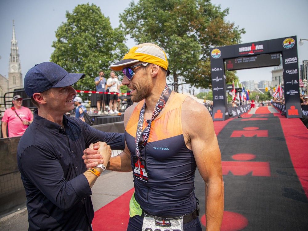  Shane Lynch was congratulated for finishing his Ironman by Scott DeRue, the CEO of Ironman.