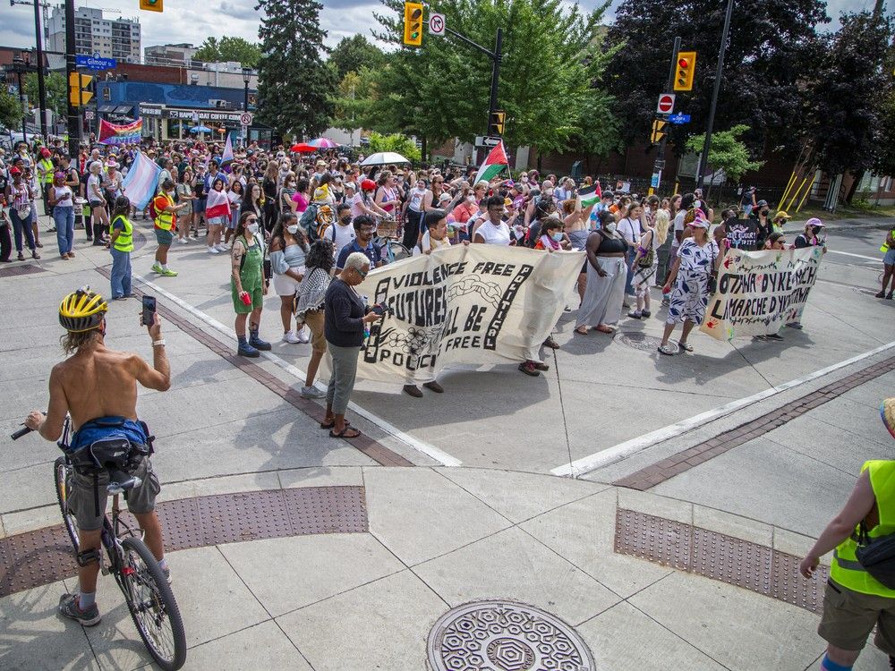 A group gathered in Minto Park on Saturday before marching onto Elgin Street for the annual Dyke March.
