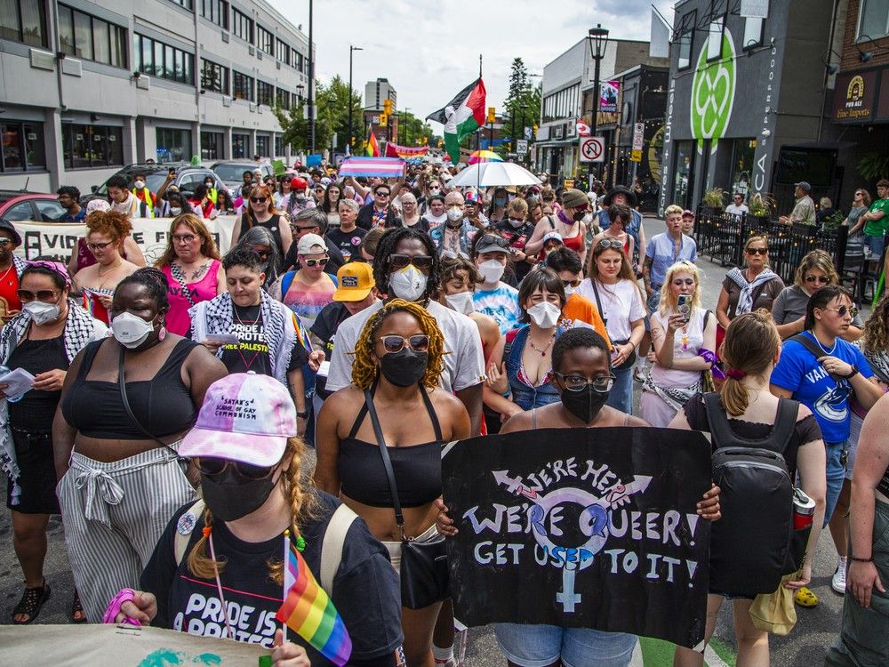  A group gathered in Minto Park on Saturday before marching onto Elgin Street for the annual Dyke March.