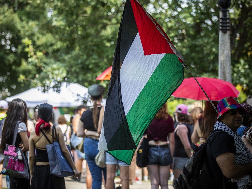  A group gathered in Minto Park on Saturday before marching onto Elgin Street for the annual Dyke March.