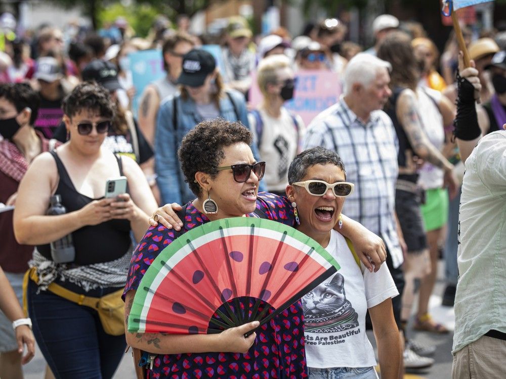  A group gathered in Minto Park on Saturday before marching onto Elgin Street for the annual Dyke March, a staple of the pride celebration weekend. This year’s march included expressions of solidarity with Palestine, with participants carrying flags and wearing keffiyehs alongside pride symbols.