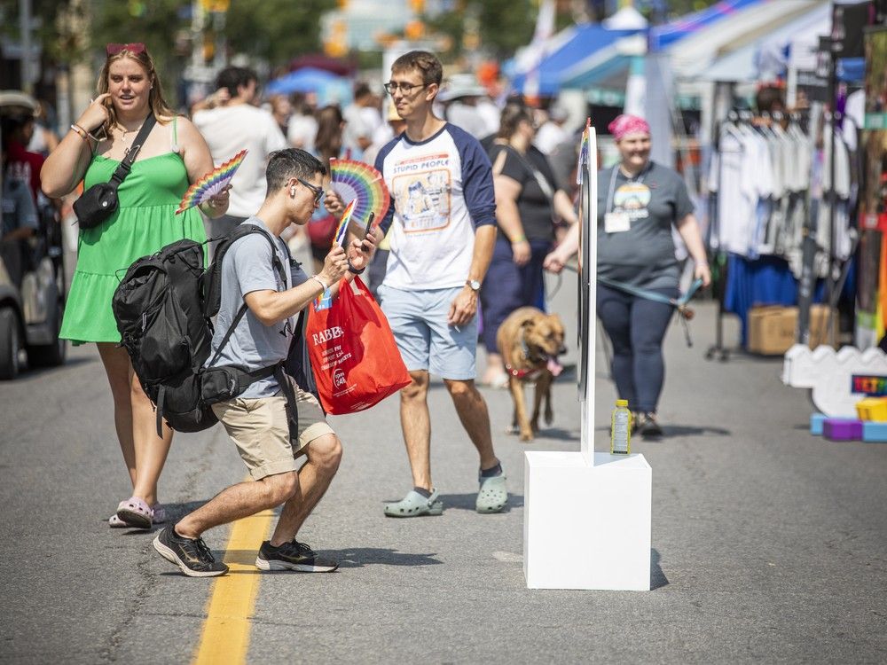  People walk down Bank Street taking in Capital Pride’s Street Festival, a celebration of 2SLGBTQIA+ communities featuring local vendors, community groups, and inclusive programming.