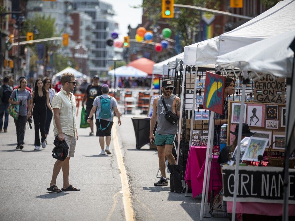 People walk down Bank Street taking in Capital Pride’s Street Festival, a celebration of 2SLGBTQIA+ communities featuring local vendors, community groups, and inclusive programming.