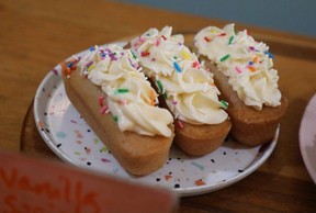 Three homemade twinkies topped with vanilla icing and sprinkles