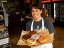 Caroline Murphy, co-owner of Corner Peach, holds a half-dozen impeccably big and fluffy house-made doughnuts.