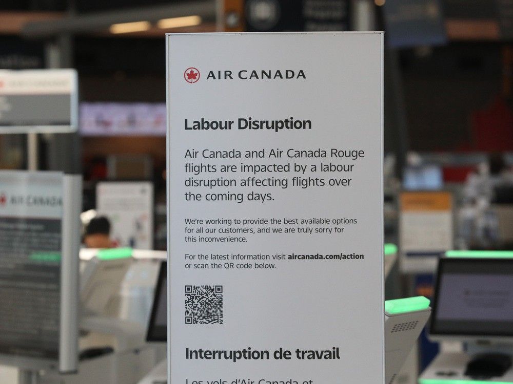  A sign posted by Air Canada on Friday at the check-in counter at Ottawa International Airport.