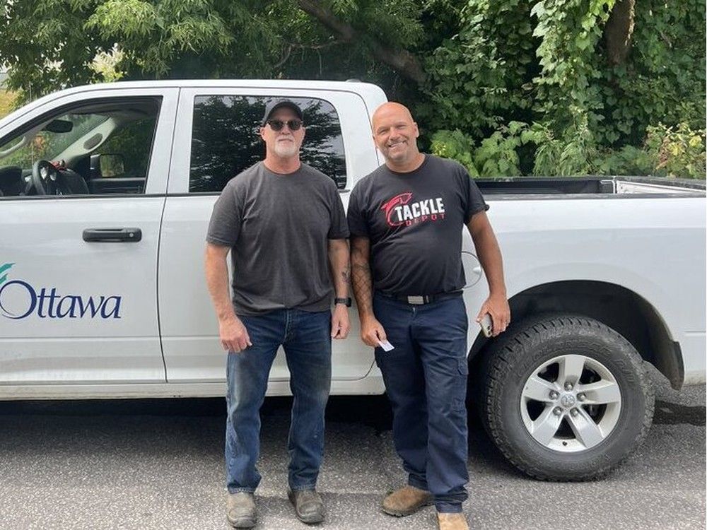  Firefighters thank city workers Rene Bilodeau and Marc Brule who guided the rescuers to the trapped hiker. Photo by Ottawa Fire Service