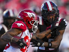 Calgary Stampeders wide receiver Kaylon Horton (88) tries to get past Ottawa Redblacks defensive back Alijah McGhee