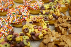 A selection of sprinkles and cereal-topped donuts