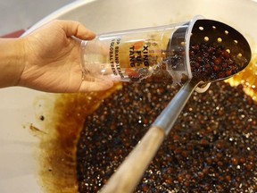 Tapioca pearls coated in Taiwanese brown sugar syrup are transferred from wok to cup at Xing Fu Tang.