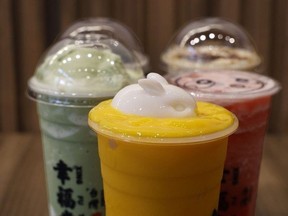 A selection of drinks including a yellow smoothie topped with a jelly bunny.