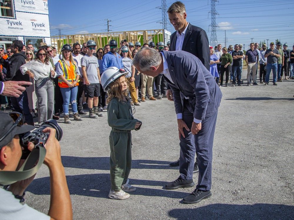  Prime Minister Mark Carney greets one of the youngest attendees of the event who was wearing her hard hat after the press conference Sunday.