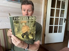 man reads book with astonished look on his face