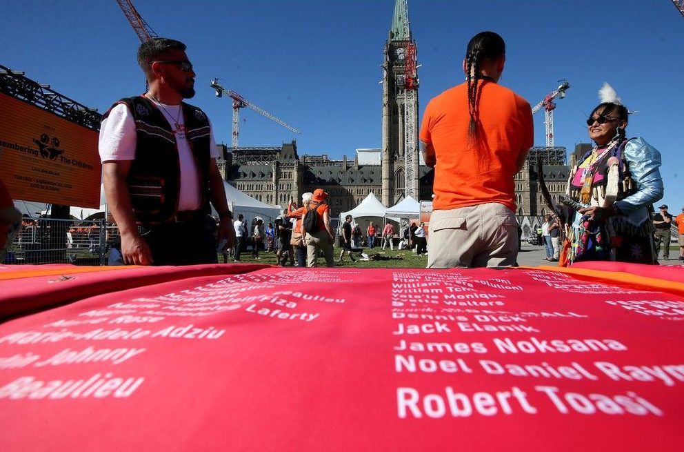  The names of those lost were printed on a large red cloth that was going to be carried to the stage as ceremonies got underway.