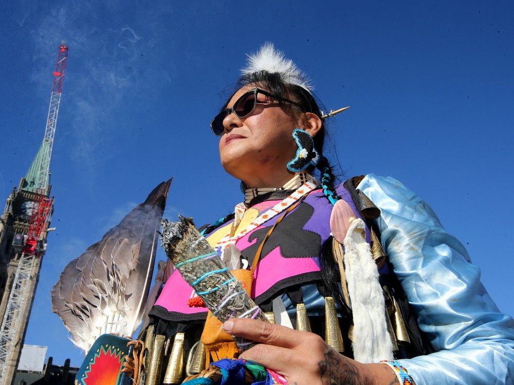  Dressed in a traditional jingle dancer’s dress, Candice Anderson Schultz spoke of her mother, Roberta Anderson, who was a residential school survivor.