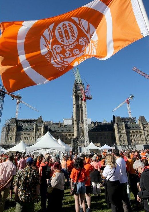  The orange flags of Truth and Reconciliation flew in front of Parliament Hill for the event.