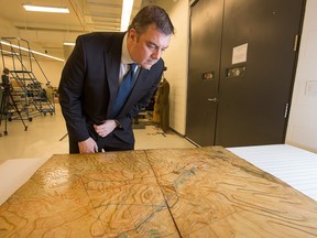 Historian Dr. Tim Cook with the Vimy Ridge wooden relief map used by Canadian commanders preparing for battle at the Canadian War Museum.