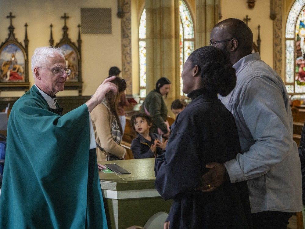 Father Stephen Amesse talks to parishioners after mass on Sunday, Oct. 26, 2025.  Father Stephen Amesse talks to parishioners after mass on Sunday, Oct. 26, 2025.