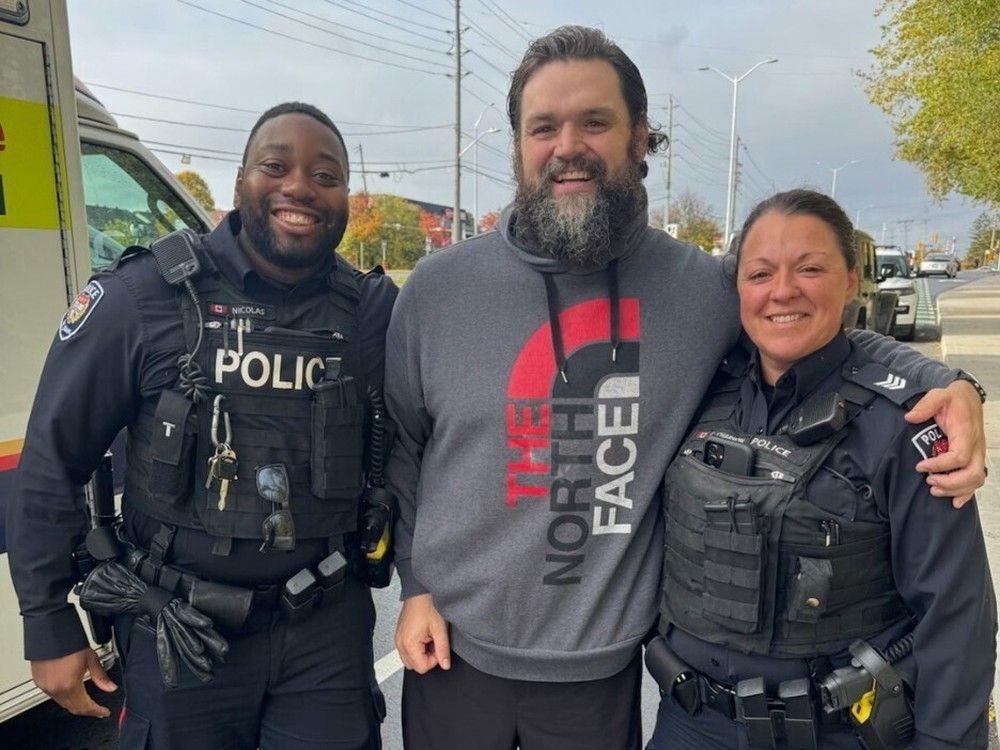 Ottawa Police Service Const. Nicolas, left, and Sgt. Charron, right, with father Jeremie after the birth of Jeremie’s son, Jack, alongside Highway 174 on Friday.  Ottawa Police Service Const. Nicolas, left, and Sgt. Charron, right, with father Jeremie after the birth of Jeremie’s son, Jack, alongside Highway 174 on Friday.
