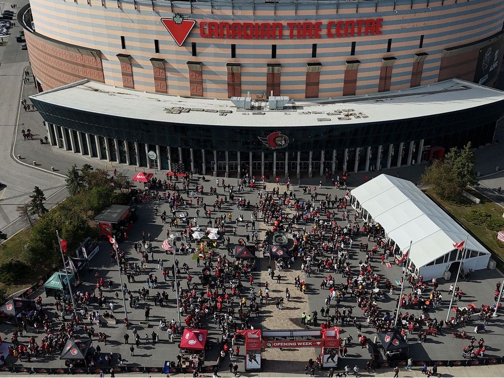 Sens fans enjoying the nice weather outside Canadian Tire Centre before the home opener Monday.